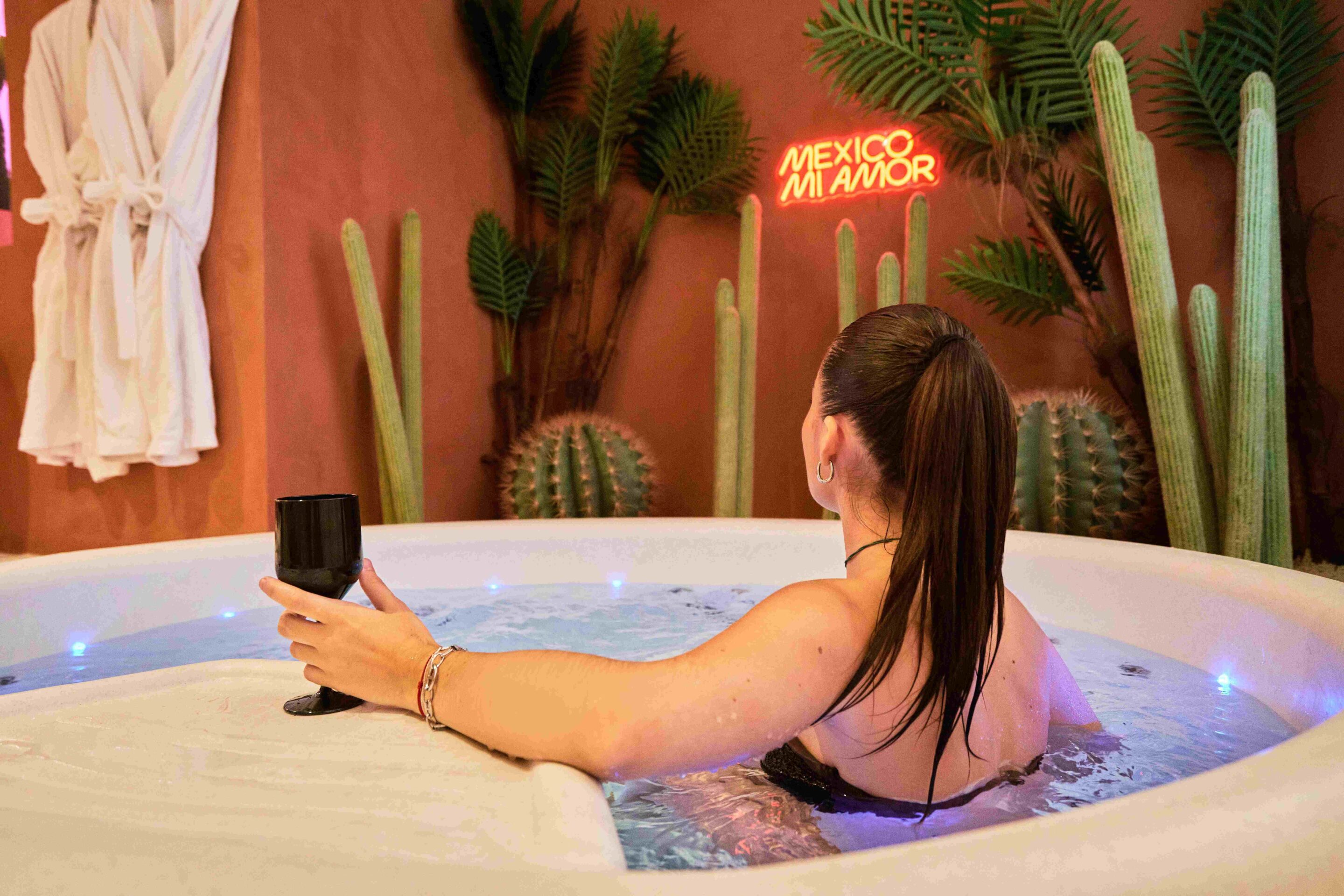 femme dans le jacuzzi avec son verre et cactus en fond scaled